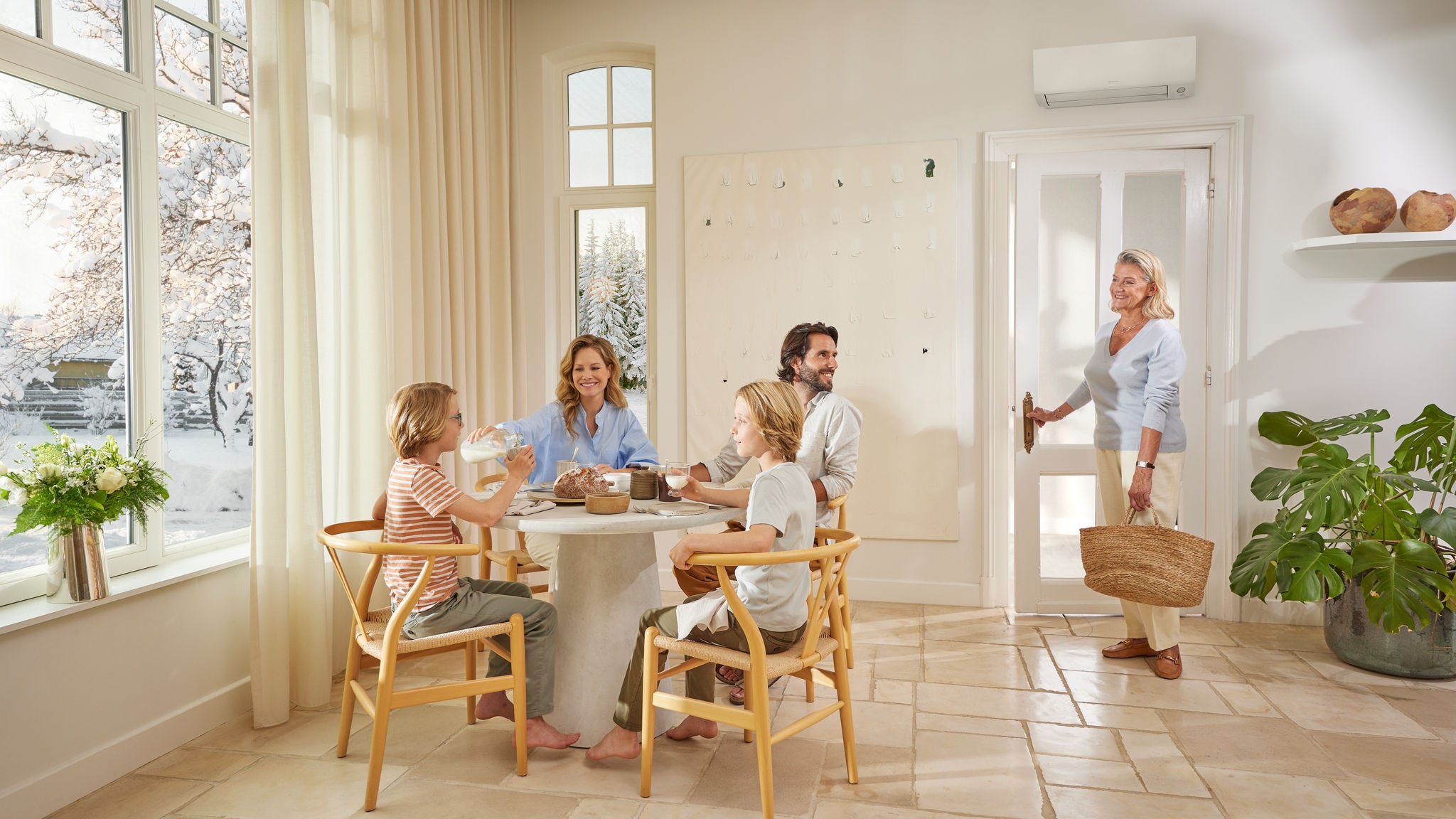 Family relaxing in living room, showing the comfort and cooling provided by Daikin's home comfort solutions